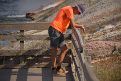 1_Tired-Tourist-On-Walkway-Midway-Geyser-Basin-At-Yellowstone-National-Park-In-Wyoming_